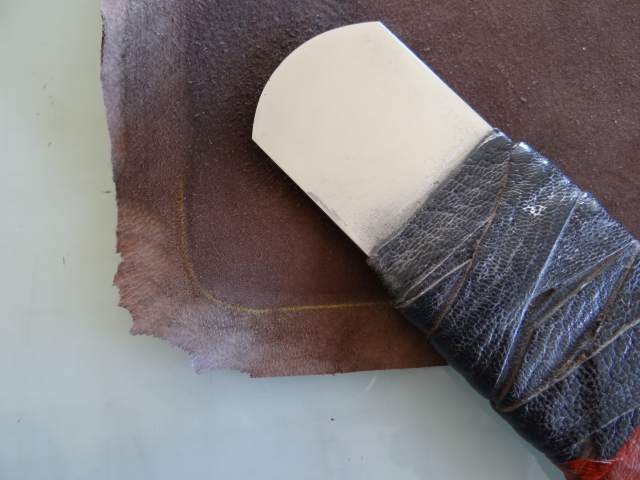 The goatskin is pared and ready to paste. This shows he paring for the rounded portfolio corners