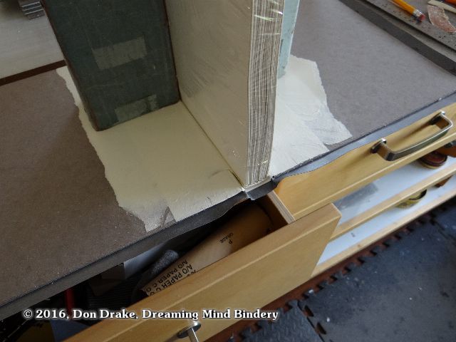 A detail showing how a hand made book may be positioned while the inside covers are sanded