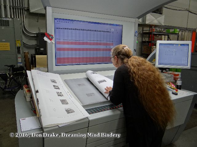 Kate Jordahl checking a press sheet for the One Poem Books #5 & 6