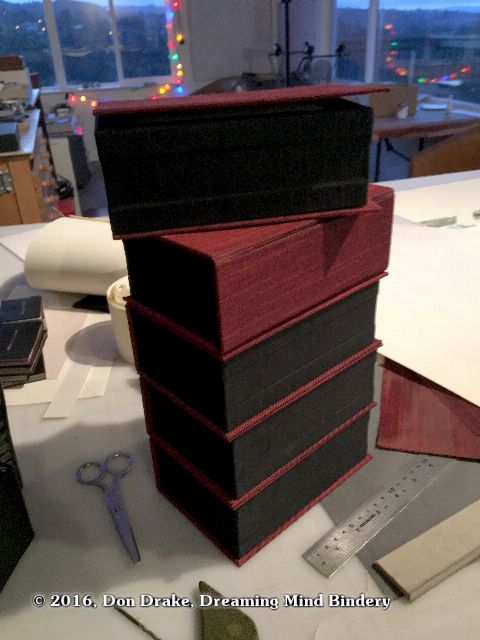 A stack of 'Amending Self' boxes, partially assembled